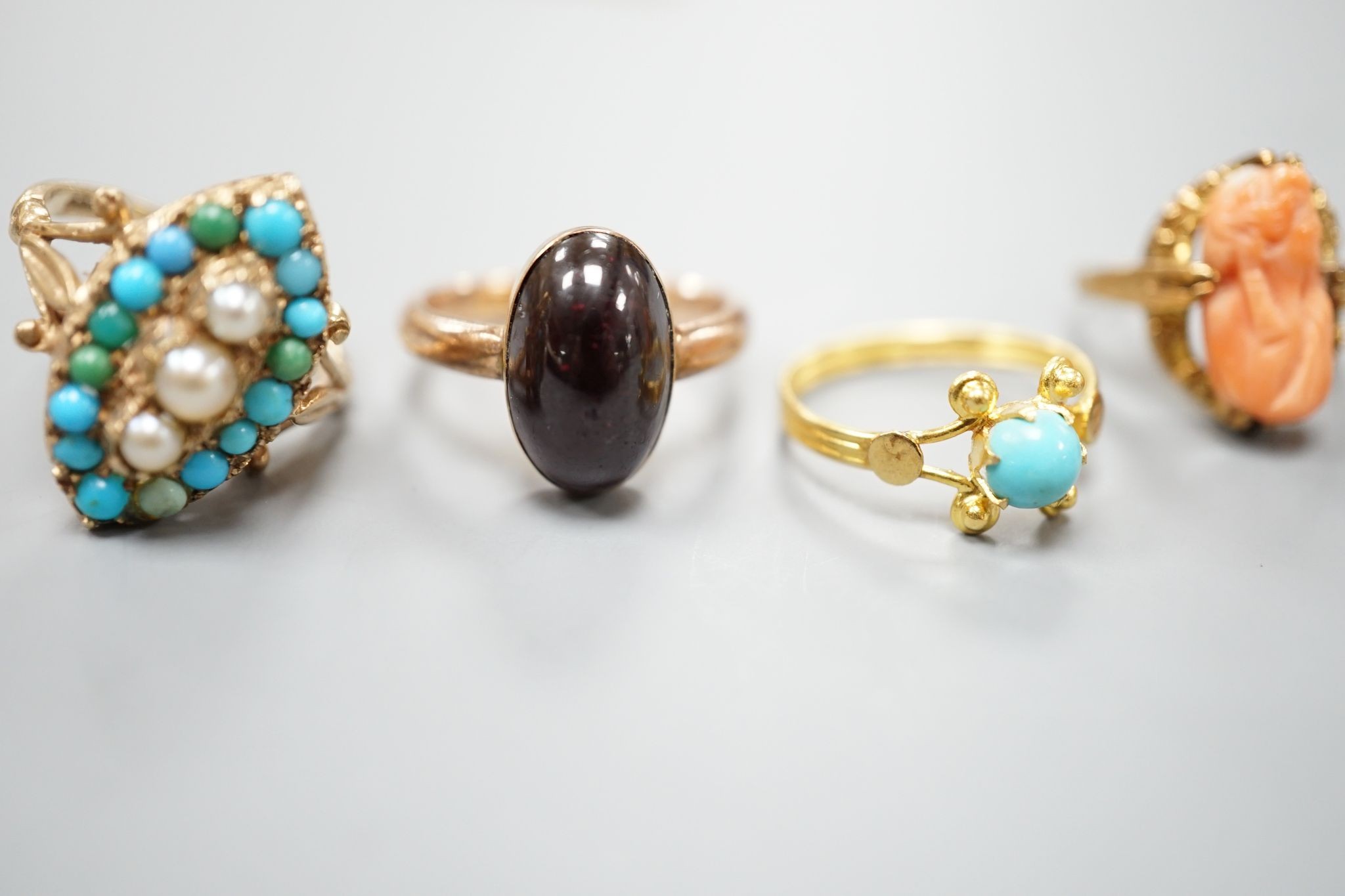 Three assorted modern 9ct gold and gem set ring including turquoise and seed pearl, gross 11.2 grams, a 10k and coral set ring, gross 2.7 grams and a yellow metal and turquoise set ring, gross 1.3 grams.